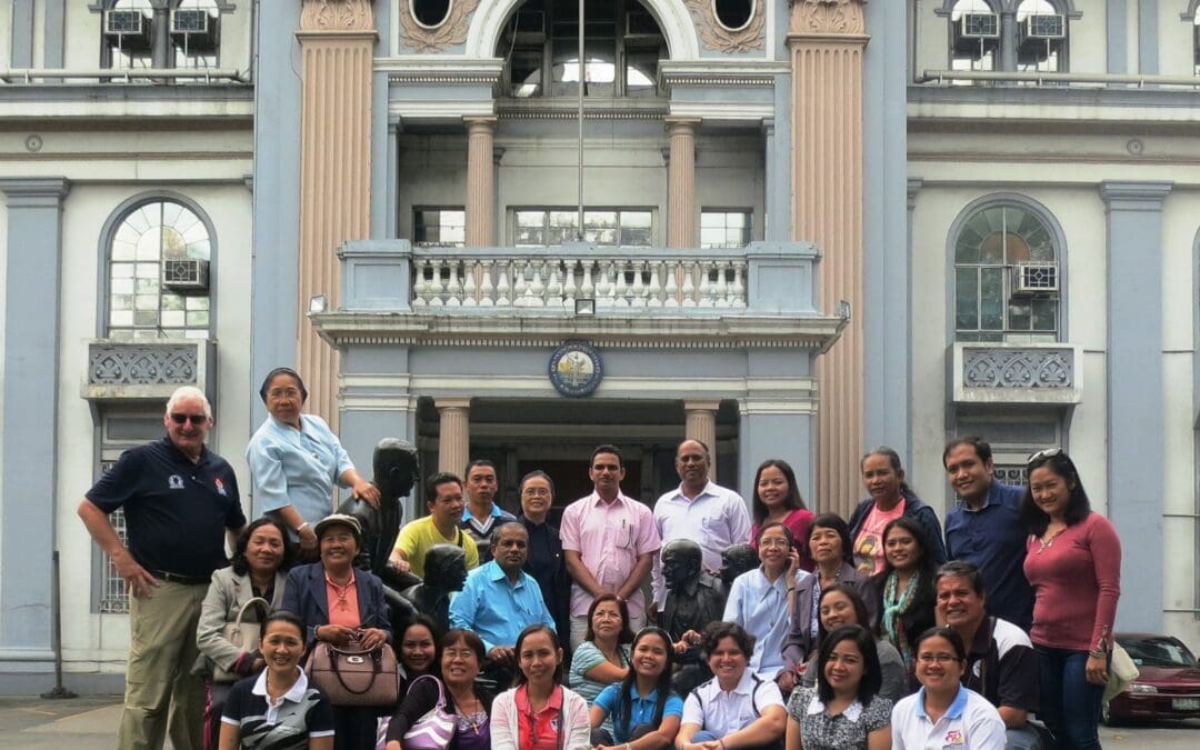 Delegates by the jubilee sculpture at AdU